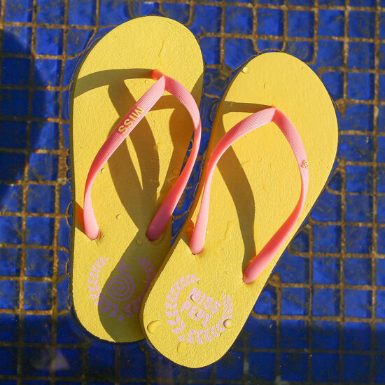 Lightweight women’s beach flip flops with red PE sole